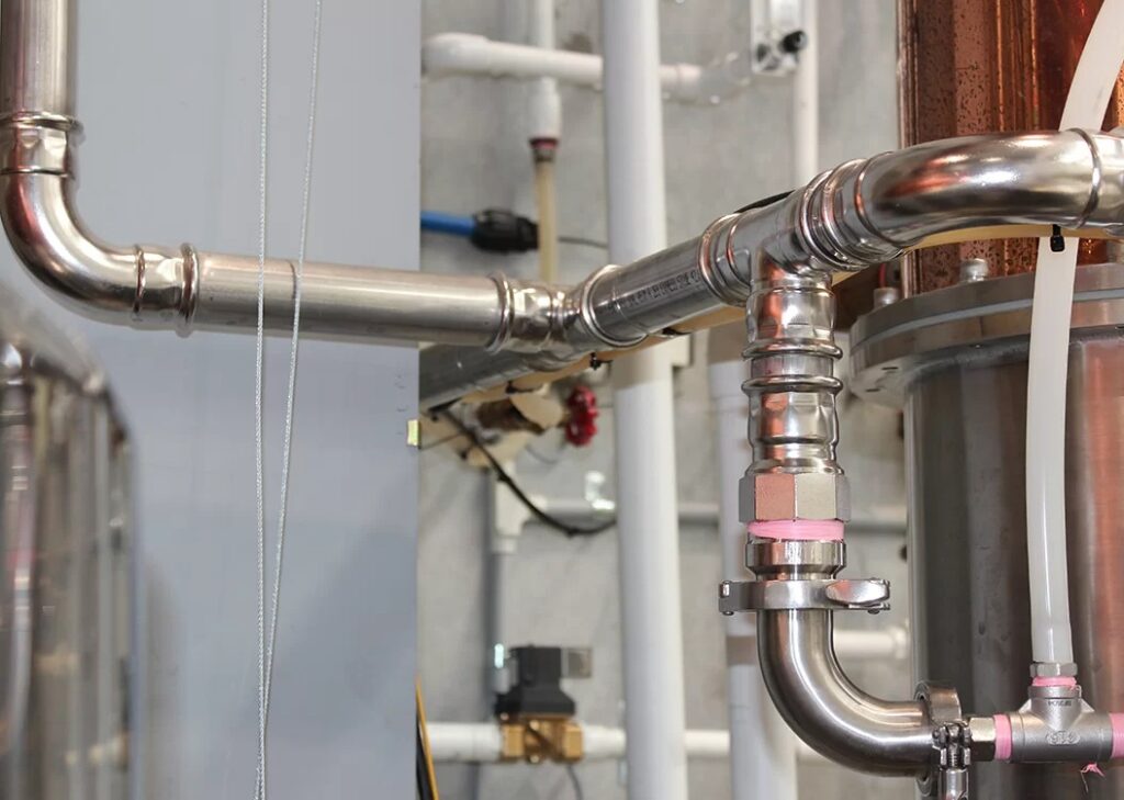 Stainless steel press-fit pipe system showing a welded-free connection used in industrial applications